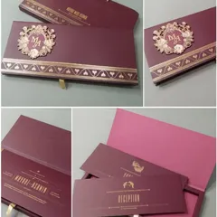 A rich burgundy boxed invitation featuring a custom laser-cut monogram with floral details. This elegant set comes with a matching bag and is perfect for a formal, upscale wedding.