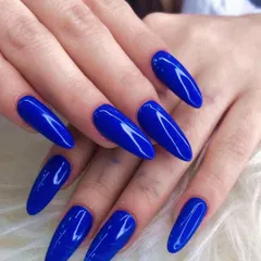 Make a statement with these long, almond-shaped nails in a stunning metallic royal blue. The high-gloss finish gives this manicure a liquid-metal look that is incredibly eye-catching.