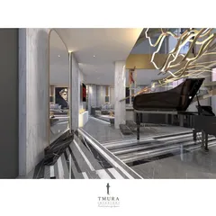 A grand piano is positioned at the base of the floating staircase, reflected in a large, arched mirror. The entire composition, including the striped marble floor and sculptural chandelier, creates an unforgettable foyer.