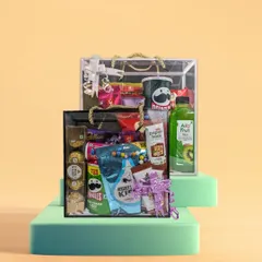 A great gift is one your guests will actually use and enjoy. Our customizable gift hampers are designed for just that. This clear hamper bag is filled with popular treats like Pringles, Ferrero Rocher, and Paper Boat drinks, showing how you can create a fun and memorable thank you gift for any event.
