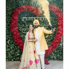 Adding a modern twist to the Haldi entry with colorful smoke bombs. This creates a dynamic and unforgettable photograph that is full of energy.