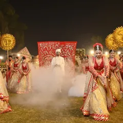 A groom's entrance sets the tone for the celebration. I choreograph powerful arrivals like this one, using dramatic smoke effects and a troupe of synchronized dancers to build excitement and create a grand, memorable welcome.