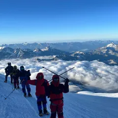 A moment of pure triumph on Mount Elbrus, the highest peak in Europe. Standing above a sea of clouds, our climbers soak in a view that few will ever witness. This is the reward for every hard step taken on the journey to one of the Seven Summits.