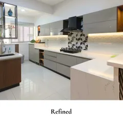 This kitchen blends modern style with everyday practicality. The geometric tile backsplash behind the stove adds a fun, graphic element, while the sleek grey cabinets and white countertops keep the look clean and refined.