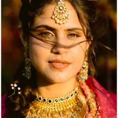 A stunning bridal portrait at golden hour. The wind catches her hair, the light catches her eyes. A moment of pure, confident beauty.