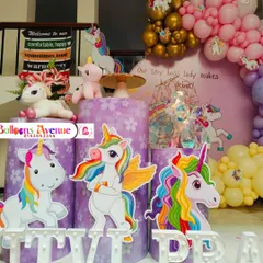 A detailed shot of the unicorn-themed cake stands and character cutouts, adding to the enchanting atmosphere.