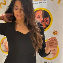 A happy client, shining bright after her hair transformation at my salon.