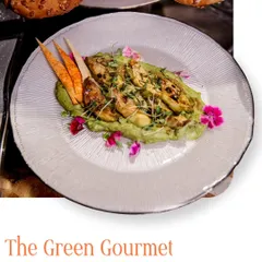 We call this The Green Gourmet. This plate speaks in greens, textures, and timeless taste, featuring grilled artichokes on a bed of vibrant green puree with edible flowers.