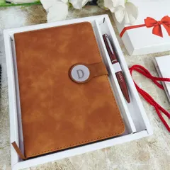 A closer look at the Camel Brown diary set, showing the fine details of the personalized pen and the magnetic lock. The diary contains 200 lined pages and a calendar, making it a very useful gift.