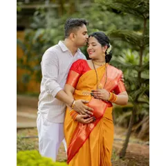 An intimate moment during an outdoor maternity photoshoot. We find that natural, green settings in places like Mangalore and Udupi help couples relax, allowing us to capture genuine affection and anticipation.