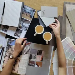 This is where the magic begins. A flat lay of a mood board shows our process of selecting color palettes, material samples, and inspirational images to define the aesthetic and feel of a new project.