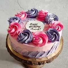 A cake for Amma, made with all my love. This beautiful strawberry cake is decorated with delicate pink and purple buttercream roses, showing that a cake can be as beautiful as it is delicious.