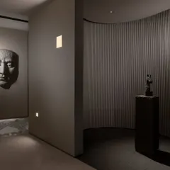 We use lighting to create distinct zones and moods. Here, wall-washing lights and focused spotlights draw attention to art pieces and architectural details, guiding the visitor's journey.