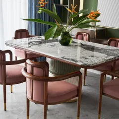 Meet the “Pellet Drum” dining table, a piece inspired by the form of Shiva’s damru. Its base features grooved spheres finished in dual-tone polyurethane, supporting a magnificent Patagonia marble top. Paired with our bent teakwood 'Svelte' chairs, this set makes every meal a statement.