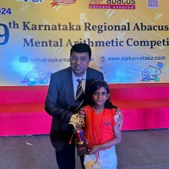 A proud moment as one of our students receives her trophy and medal at the state-level competition. Her hard work and dedication have truly paid off.