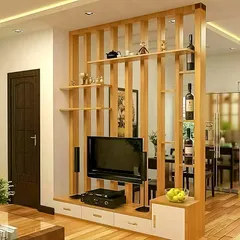 This wooden partition is a great example of how I divide spaces functionally without building a solid wall. It acts as both a TV unit and a display shelf, maintaining an open and connected feel between the living and dining areas.
