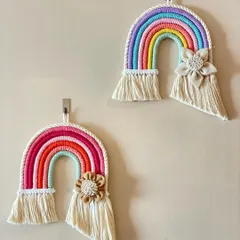These large macrame rainbows are a customer favorite. They can be customized with or without the floral accent and come in a variety of color palettes to match any room decor.