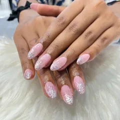 Acrylic extensions are perfect for creating elegant shapes like this almond look. I applied a beautiful 'falling glitter' design, blending the silver sparkles down from the tip for a glamorous and eye-catching effect.