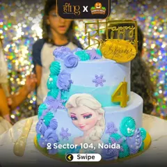 A close-up of a beautiful two-tier cake for a Frozen-themed party, featuring Elsa and intricate snowflake details. I work with bakers to create cakes that match your theme perfectly.