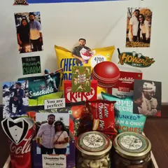 Score a six with this cricket-themed birthday hamper. It's perfect for a fan of the sport, featuring a cricket ball, bat cutouts, and plenty of snacks to enjoy while watching the game.