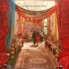 For a truly unique Mehendi, we designed this immersive Banaras ghat themed entrance. The vibrant red floral walls, traditional temple bells, and intricate carpet runner transported guests to the ancient city, setting the stage for a culturally rich celebration.