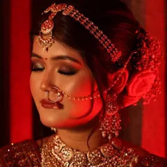 This traditional bridal look features a classic smokey eye with gold glitter and a bold lip. Creating such detailed looks requires precision and an understanding of how makeup performs under different lighting, a skill I bring to every shoot.