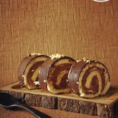 Just roll with it. Our chocolate Swiss roll features a light sponge cake swirled with a rich chocolate cream, all coated in a layer of smooth chocolate and sprinkled with nuts.