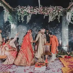 This mandap was designed with a canopy of hanging flowers and a mirrored structure. The addition of cold-pyro sparklers during the pheras added a touch of modern celebration to the traditional ceremony.