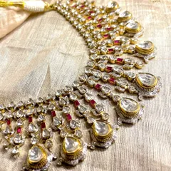 This Polki and Ruby masterpiece is designed for unapologetic grandeur. The cascading uncut diamonds and vibrant rubies create a look of pure heritage and elegance, defining your presence in any room.