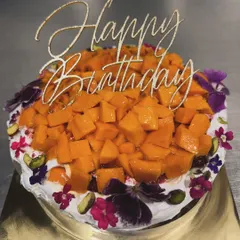 During mango season, I give my Basque burnt cheesecake a tropical twist. It's topped with fresh cream, sweet organic Alphonso mangoes, and a sprinkle of edible flowers for a beautiful finish.