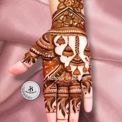 This is another take on the jhumka design, with an Arabic-style vine on the side of the hand. The hanging bells add a playful touch to the elegant floral and paisley patterns.