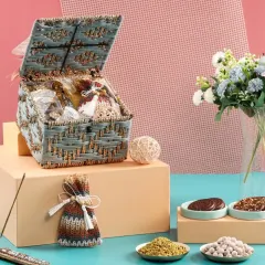 A closer look at our blue and gold woven jute box, filled with delicious treats. The natural texture of the jute combined with the elegant embellishments creates a unique gift.