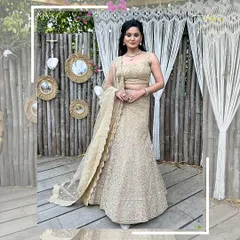 A full-length shot of the beige lehenga against a rustic backdrop, showing its timeless elegance.