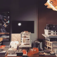 A view of our studio's model table, a landscape of past and present projects. Each model represents a deep exploration into form, space, and materiality, serving as a physical library of our design thinking.