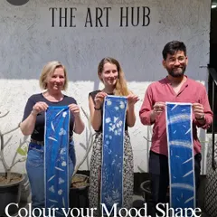 A team proudly displays the beautiful fabric art they created together. Our workshops are a great way to color your mood, shape your mind, and create something beautiful as a group.