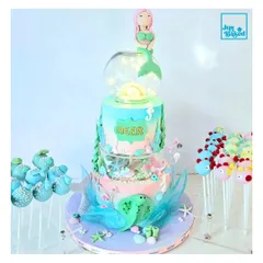 This three-tier mermaid cake is a perfect example of how I bring fairytales to life. It features ocean-inspired colors, edible sea creatures, and even fairy lights to create a magical underwater world for a special birthday.