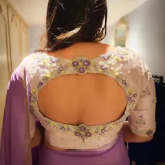 The back of the blouse I designed for Divya Spandana is a work of art in itself. The keyhole cutout is beautifully framed with intricate floral embroidery, showing how I focus on making every angle of an outfit special.
