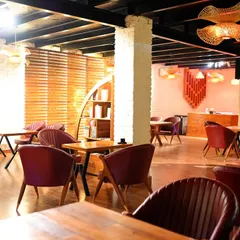 A look inside my chic indoor dining hall. It features modern wooden furniture, stylish lighting, and a warm ambiance, perfect for when you want to move the party indoors.