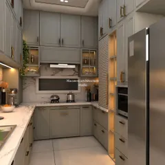 This angle of the grey shaker-style kitchen shows the smart storage solutions, including open-lit shelving and a dedicated pantry unit next to the refrigerator.