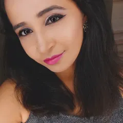 A selfie showing a fun party look. This features a sharp winged liner, shimmery silver eyeshadow, and a bright fuchsia pink lip for a modern and trendy vibe.