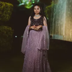 A client looking elegant in a lavender-grey lehenga for an evening function. The dark, embellished blouse contrasts beautifully with the intricately embroidered skirt.