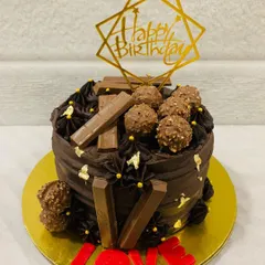 A rich chocolate truffle cake decorated with KitKat bars, Ferrero Rocher, and the word "LOVE" in red fondant. A perfect gift for your favorite person.