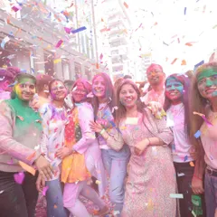 A moment of shared joy at a corporate Holi party. This photo captures employees smiling and covered in colors under a shower of confetti, reflecting the fun and engaging atmosphere we create.