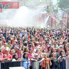 The huge crowd at the Holi festival enjoys the celebration as water and colors fill the air. We manage all aspects of crowd safety and experience, including amenities like rain dance setups.