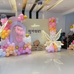 A stunning butterfly-themed welcome decoration with modern arched backdrops, a personalized neon sign, and large, elegant light-up butterfly wings.