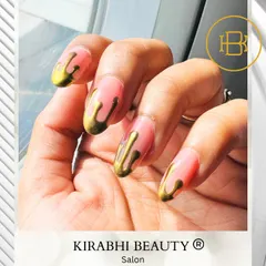A full view of the gold drip nail art on a sheer pink base. This design is perfect for anyone wanting a bold and artistic manicure.