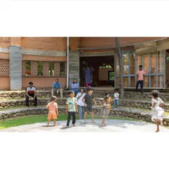 Architecture can bring people together. This stepped, semi-circular seating area at the Foothill Learning Centre serves as an informal gathering spot, encouraging interaction between children and adults in a relaxed, open-air setting.