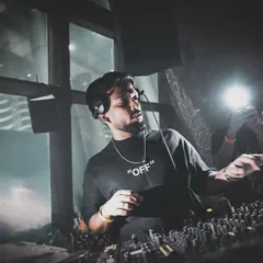 In deep concentration, selecting the next track. A great DJ set is all about telling a story, and every song choice matters.