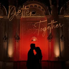 A powerful silhouette shot against a grand, illuminated backdrop. This image captures the romance and drama of a cocktail night, symbolizing the couple's unity with the phrase "Better Together."