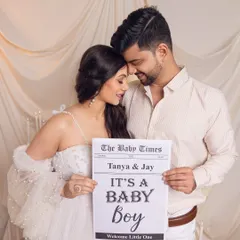 A tender moment from their gender reveal shoot. The focus is on their connection as they share their happy news.